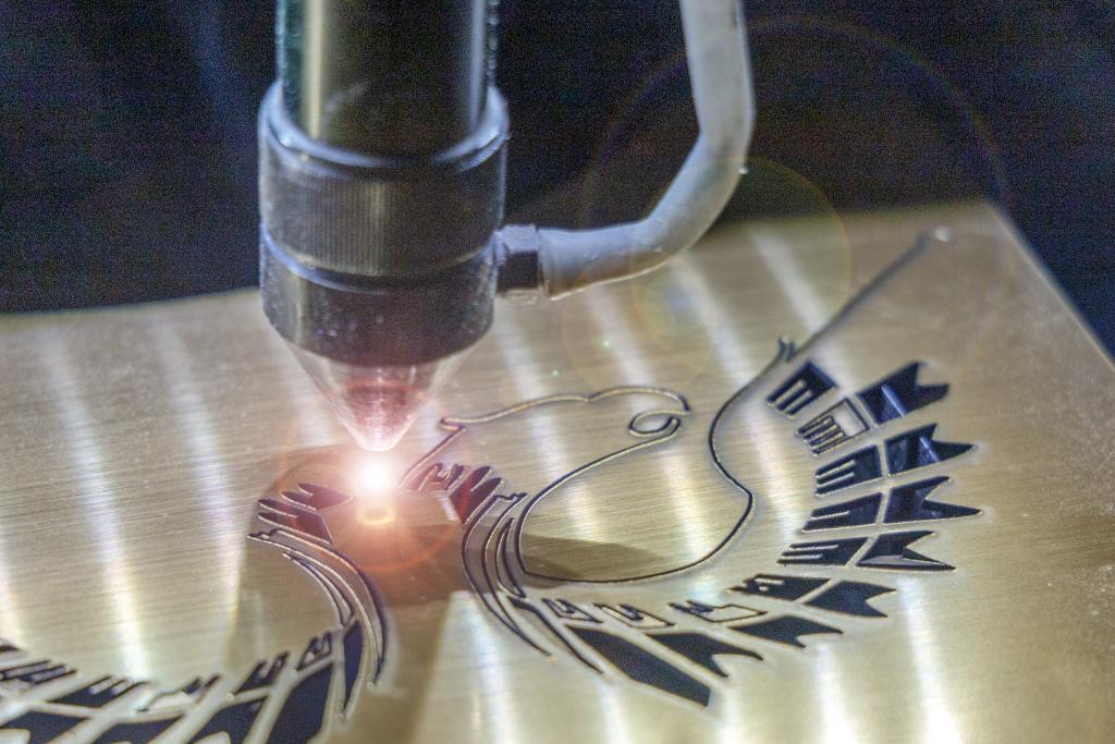 A laser engraver cutting out an intricate design.