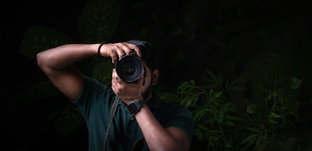 Photographer with professional camera and taking picture of nature