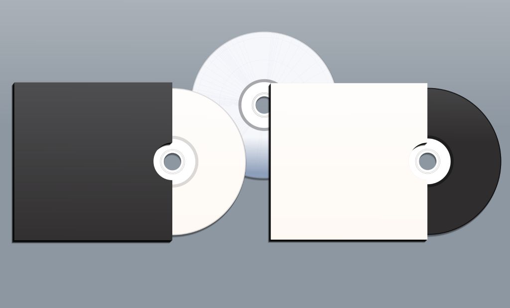 Two CDs half inside blank CD sleeves
